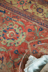 Antique Mahal carpet detail: worn cinnabar red field, oversized palmettes, and meandering vines.