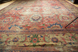 Antique Persian Mahal rug, showing worn cinnabar red field, palmettes, vines, and border.