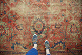 Mahal carpet detail with mostly even wear exposing knot heads, cinnabar, navy, and copper green palmettes.