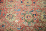 Patinaed surface of antique Mahal carpet, showing worn cinnabar palmettes and vines.