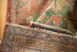 Antique Mahal carpet showing its cinnabar red selvedge, aged fringe, and pale woven foundation.