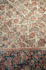 Antique Mahal carpet with worn ivory Herati motif, blush, blue, and a rich navy border.