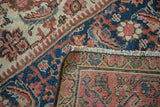 Intricate herati pattern detail on antique Mahal carpet, showing navy, blush, ivory, and woven back.