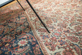Antique Mahal carpet with intricate herati pattern in navy, ivory, and blush tones, foundation showing.