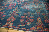 Close-up of Vintage Mahal rug's distressed indigo field, large red floral blossoms, soft green.