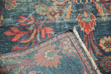 Vintage Mahal carpet detail: distressed indigo pile, red florals, exposed foundation, and fringe.