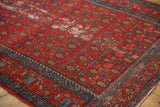 Vintage Malayer rug corner, showing storied red field with paisley and indigo border.