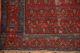 Vintage Malayer rug corner: red field, blue geometric vinery, paisley boteh, aged patina.