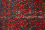 Vintage Malayer rug's textured surface, with distressed red field and indigo blue boteh pattern.