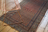 Antique Malayer rug detail: dusty blush mir boteh field with barber pole and pawn borders.