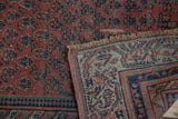 Detail of antique Malayer rug's hand-knotted reverse, Laleh Abassi 'pawn' border, navy and ivory.