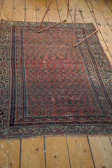 Storied wear on antique Malayer rug end, featuring dull rose field and ornate Laleh Abassi border.