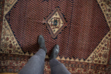 Vintage Malayer rug with dark blue mir boteh field, stepped ivory border, and mahi-mahi motifs.
