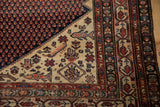 Vintage Malayer rug corner with mahi-mahi, diamond motif, ivory and navy fields, and multi-striped borders.