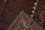 Vintage Malayer rug corner with hand-knotted backing, red border, and dark blue mahi-mahi field.