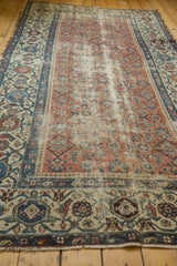 Distressed antique Persian Malayer runner field with herati motif and intricate blue border.