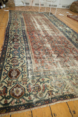 Antique Malayer runner corner with light tatter, distressed rose field, and patterned border.
