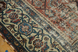 Detail of antique Malayer runner's dynamic border with sky blue, red motifs, and worn blush field.