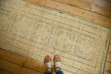 Vintage Pak Kazak runner featuring blanched beige tones and muted seafoam green elongated medallions.