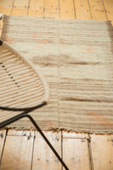 Vintage Kurdish rug's primitive woven texture, horizontal stripes, and visible central seam.