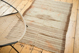 Vintage Kurdish rug's primitive horizontal brown stripes with scattered faded tangerine orange.