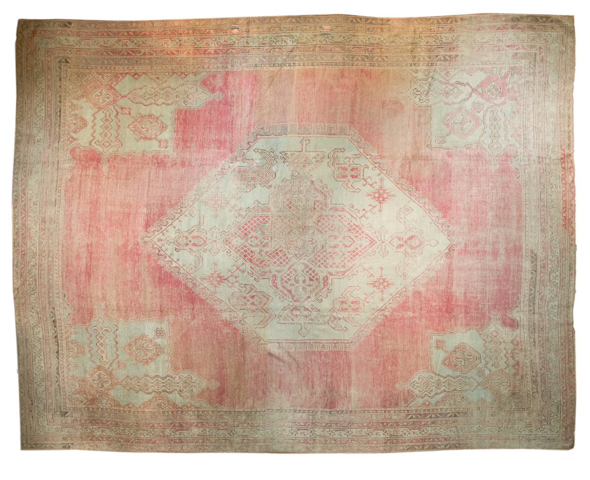 Oversize vintage Oushak carpet with a hexagonal medallion and spandrels in blush pink and sea foam green.