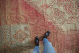 Detailed view of the vintage Oushak carpet's etched pile in blush and sea foam green.