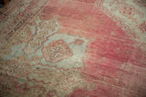 Time-softened blush and sea foam colors on the etched pile of a vintage Oushak carpet.