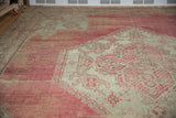Hand-knotted texture of the etched wool pile with blush and antique ivory tones.