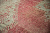 Textured low pile of a vintage Oushak carpet with areas of etching and visible knot heads.