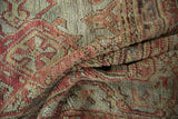 Folded view of a vintage Oushak carpet, highlighting the textured wool pile and visible knot heads.
