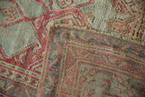 Corner view of a vintage Oushak carpet showing the etched pile and hand-knotted foundation.