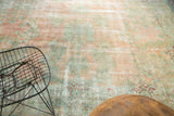 Muted blush rose and sea foam floral Kerman carpet with visible foundation wear.