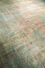 Faded curvilinear Safavid floral field and border in blush, seafoam, and antique ivory.