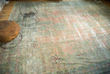 Vintage Kerman carpet's detailed border featuring faded blush, sea foam green, and cranberry floral motifs.