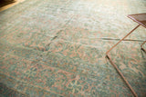 Antique Kerman rug runner showcasing blush and sea foam green floral bouquets with even wear.