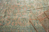 Antique Persian Kerman runner's field of soft blush, seafoam green, and ivory floral bouquets.
