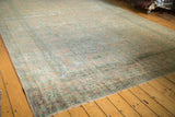 Antique Kerman rug runner corner, intricate floral border with pale blush and sea foam green patina.