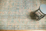 Antique Kerman runner's delicate floral bouquets in blush, sea foam, and ivory, with even wear.