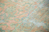 Time-softened pile of the antique Kerman runner, revealing blush and seafoam floral bouquets.