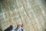 Vintage Kerman carpet surface with subtle shadow floral motifs and areas of light foundation.