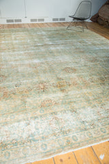 Corner detail of vintage Kerman carpet with worn sea foam green and ivory floral motifs.