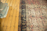 Antique Yazd carpet: prominent dark indigo floral border and faded cranberry field.