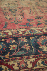 Antique Yazd carpet detail: faded cranberry field, dark indigo floral border, and even etching.