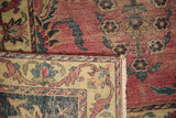 Folded corner of antique Yazd carpet, showcasing fringe, secured side, and etched pile.