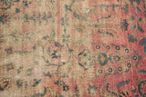 Faded cranberry red and ivory Yazd carpet with floral vinery, revealing foundation etching.