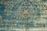 Kerman carpet detail of tree-of-life motif, floral vase, on time-softened sky blue.