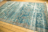 Antique Kerman carpet, distressed sky blue field, faded paisley botehs, and exposed foundation.