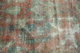 Faded dusty rose and sky blue hues on a distressed vintage Mahal carpet pile.