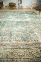 A low-angle view across an antique Mahal carpet highlighting its mostly even wear and etched foundation.